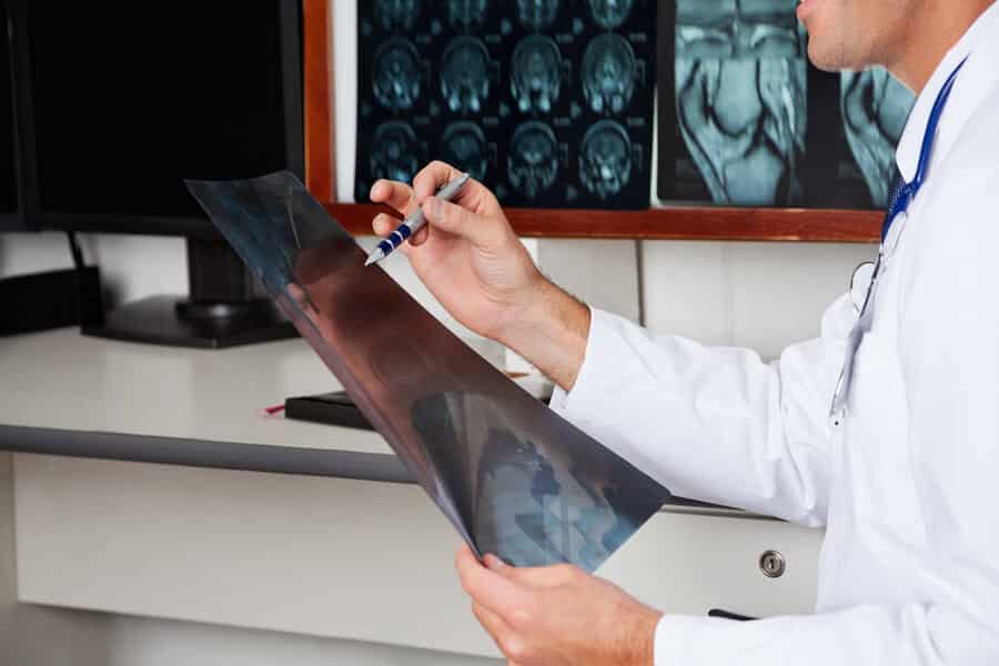 Radiologist reading x-rays at desk